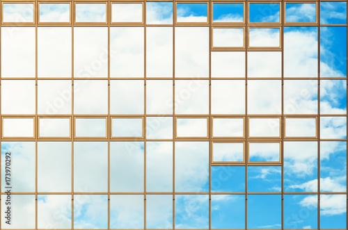 Blue sky and cloud reflect on building glass window for backgrounds