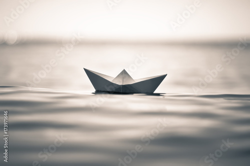 Paper boat on sea waves. toned image of paper boat. Paper boat in ocean