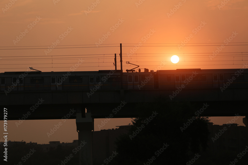 Metro train entering in to the station during sunset silhouette. Metro train entering in to the station during sunset silhouette.