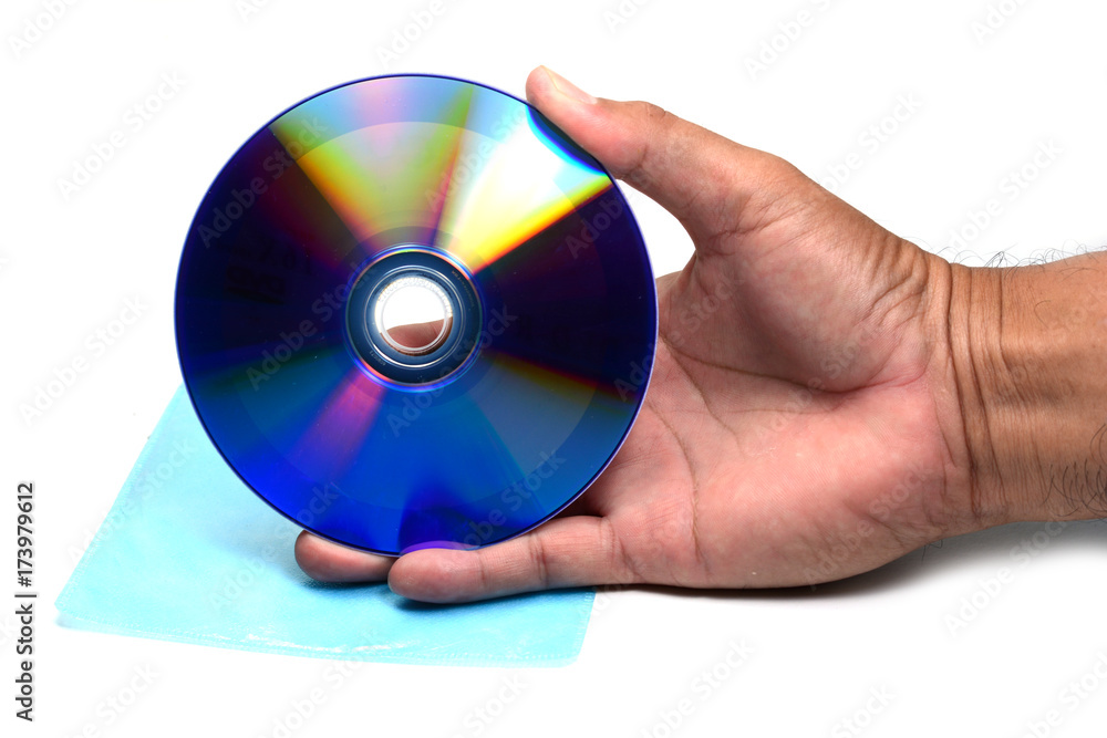 a hand holding DVD disc over plastic bag on white isolated background a hand holding DVD disc over plastic bag on white isolated background