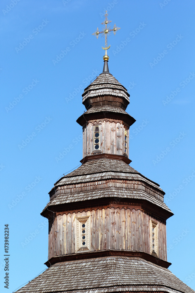 Top part of traditional wooden ukrainian church with a golden cross, cossack time period Top part of traditional wooden ukrainian church with a golden cross, cossack time period