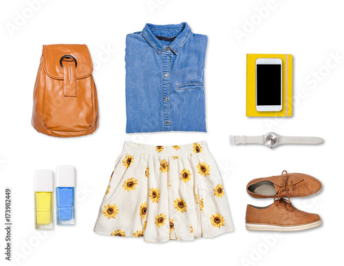 Overhead of clothes and woman accessories. Outfit of casual and modern woman on isolated white background.