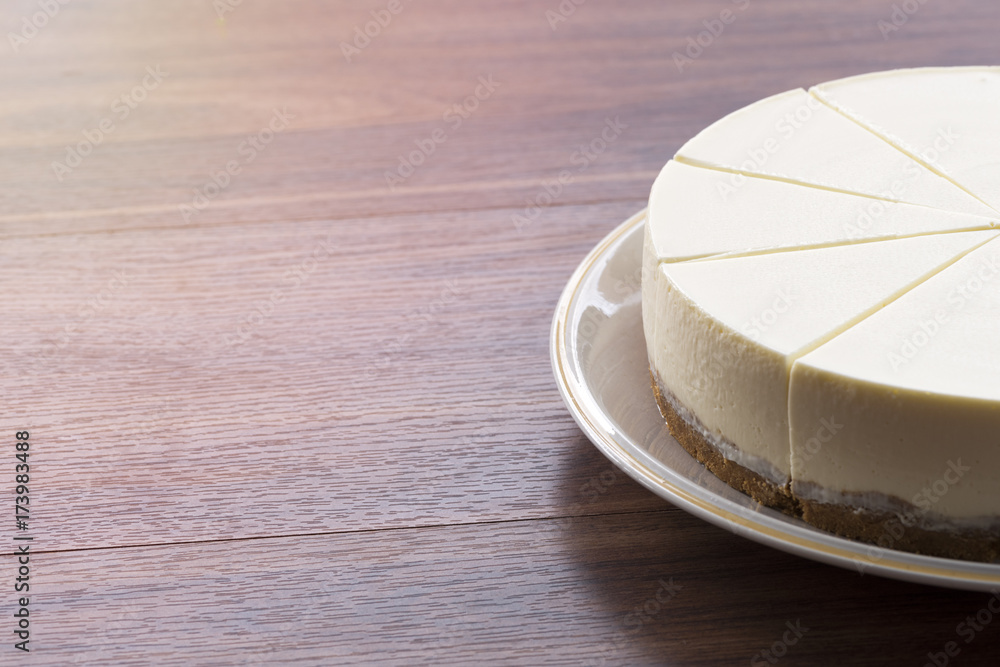 Half cream cake on wood table Half cream cake on wood table