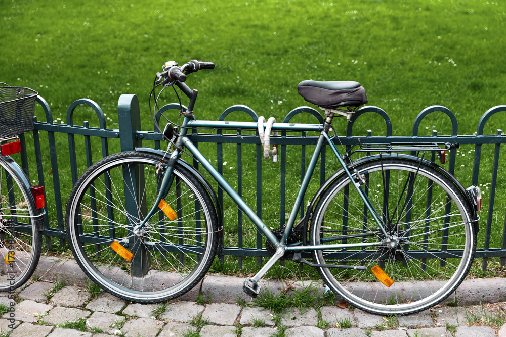 bike at the fence. urban transport. bike is securely locked to the fence