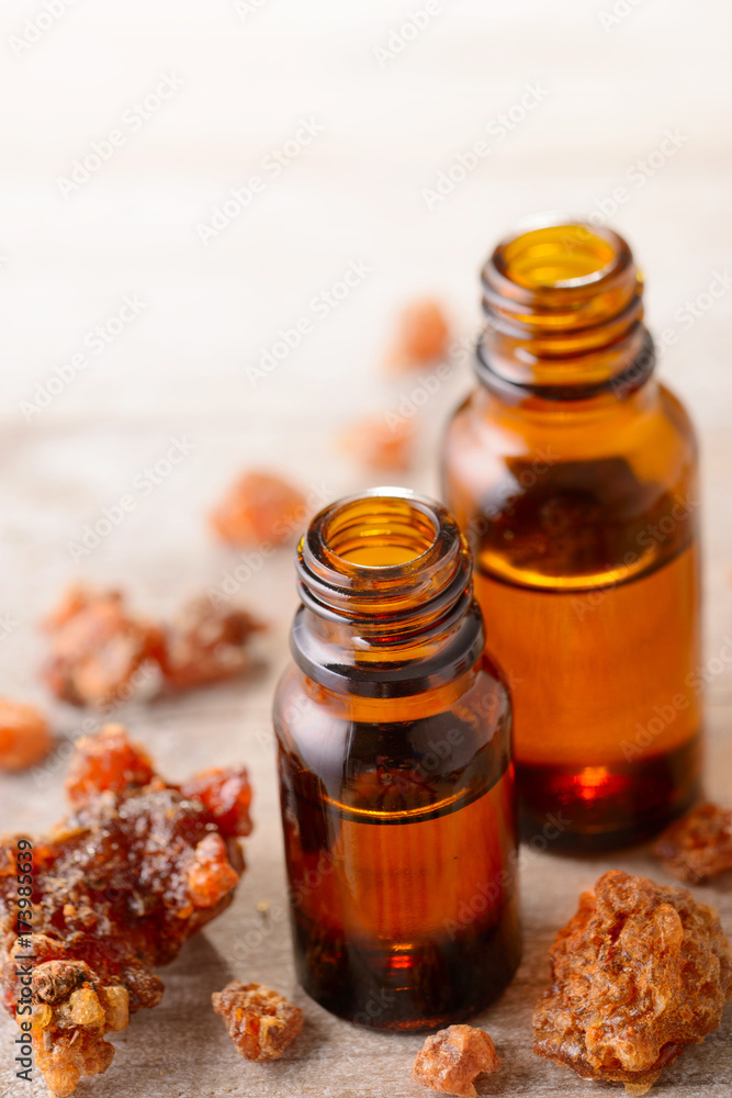 Myrrh essential oil on the wooden board Myrrh essential oil on the wooden board