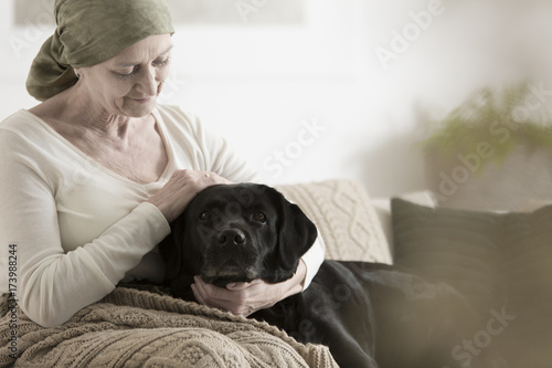 Grandmother with headscarf stroking dog