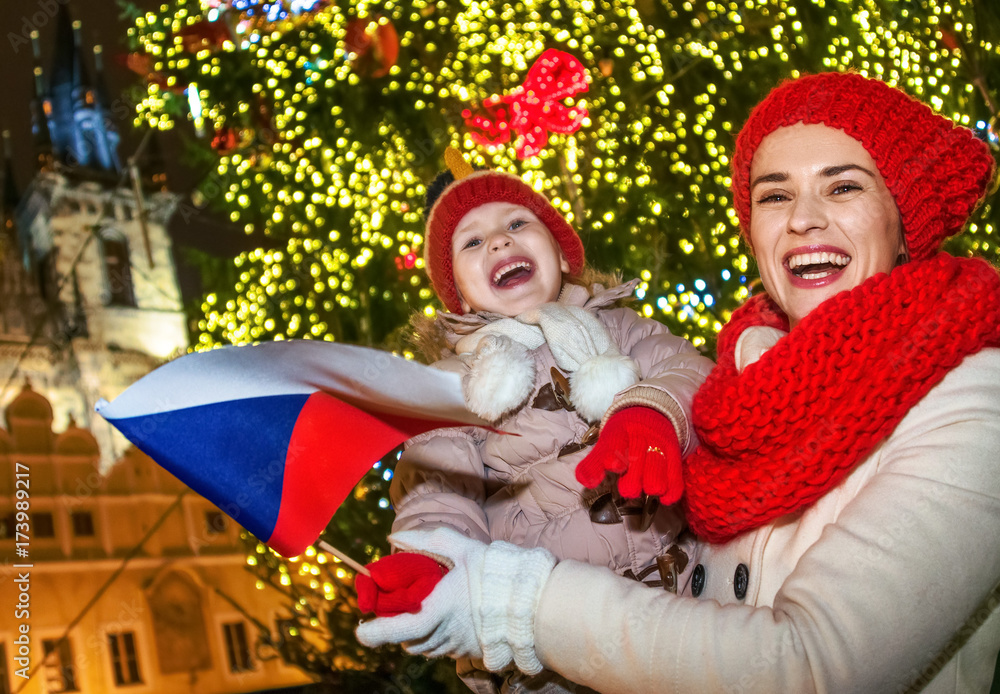 mother and child tourists at Christmas in Prague showing flag