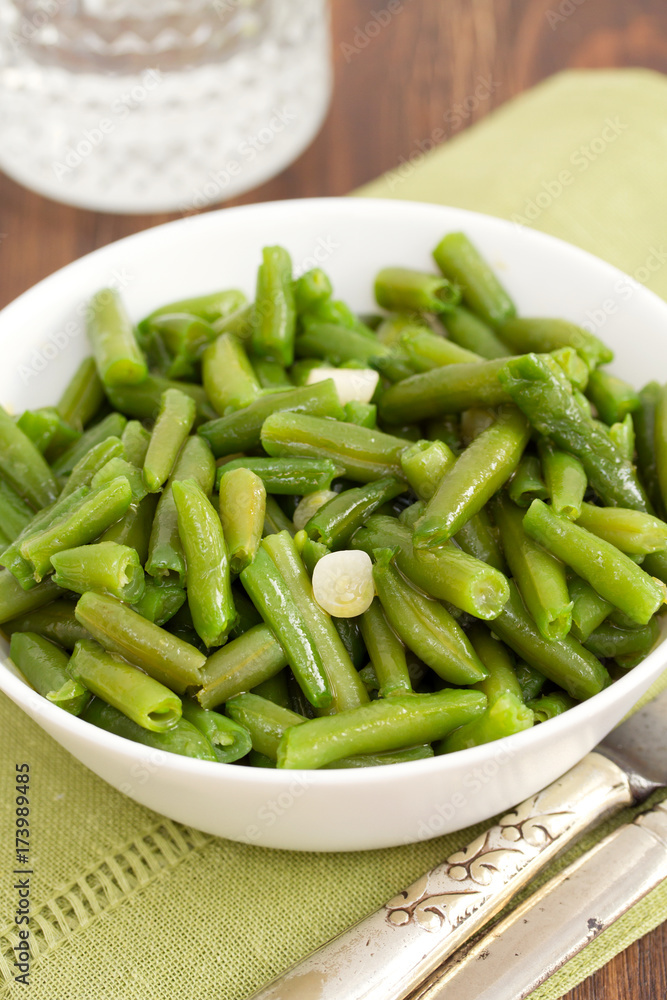 boiled green beans with garlic in white bowl boiled green beans with garlic in white bowl