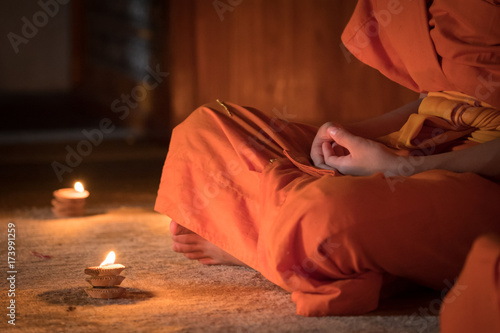 Novices monk vipassana meditation in front lighting candle