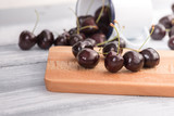 Cherries on wooden table with water drops background