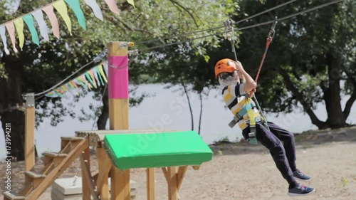 Wallpaper Mural Little cute boy enjoying activity in a climbing adventure park on a summer sunny day. toddler climbing in a rope playground structure. Safe Climbing extreme sport with helmet and Carabiner. insurance Torontodigital.ca