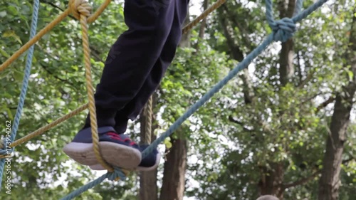 Wallpaper Mural Little cute boy enjoying activity in a climbing adventure park on a summer sunny day. toddler climbing in a rope playground structure. Safe Climbing extreme sport with helmet and Carabiner. insurance Torontodigital.ca
