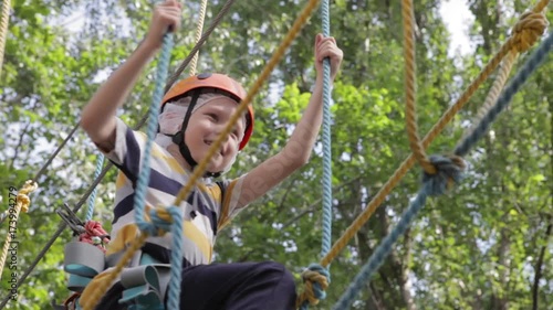 Wallpaper Mural Little cute boy enjoying activity in a climbing adventure park on a summer sunny day. toddler climbing in a rope playground structure. Safe Climbing extreme sport with helmet and Carabiner. insurance Torontodigital.ca
