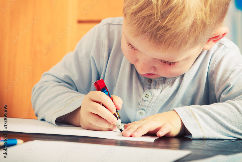 Kid playing, drawing pictures on paper Kid playing, drawing pictures on paper