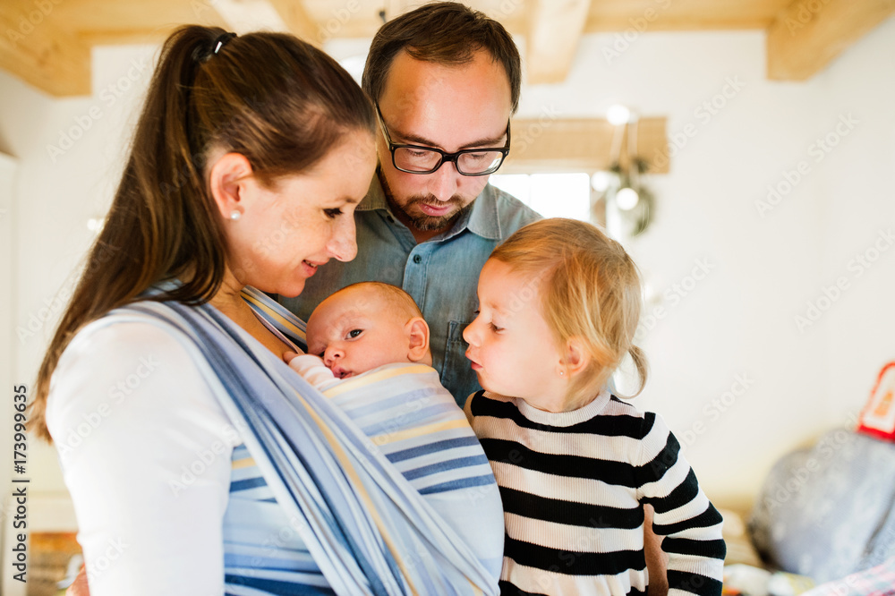 Young parents with two children at Christmas time. Young parents with two children at Christmas time.