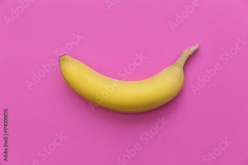 Yellow banana on bright pink background