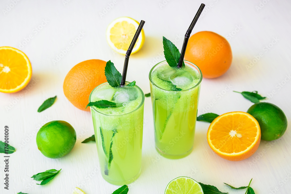 Transparent refreshing cocktail with cucumber, limes and orange Transparent refreshing cocktail with cucumber, limes and orange