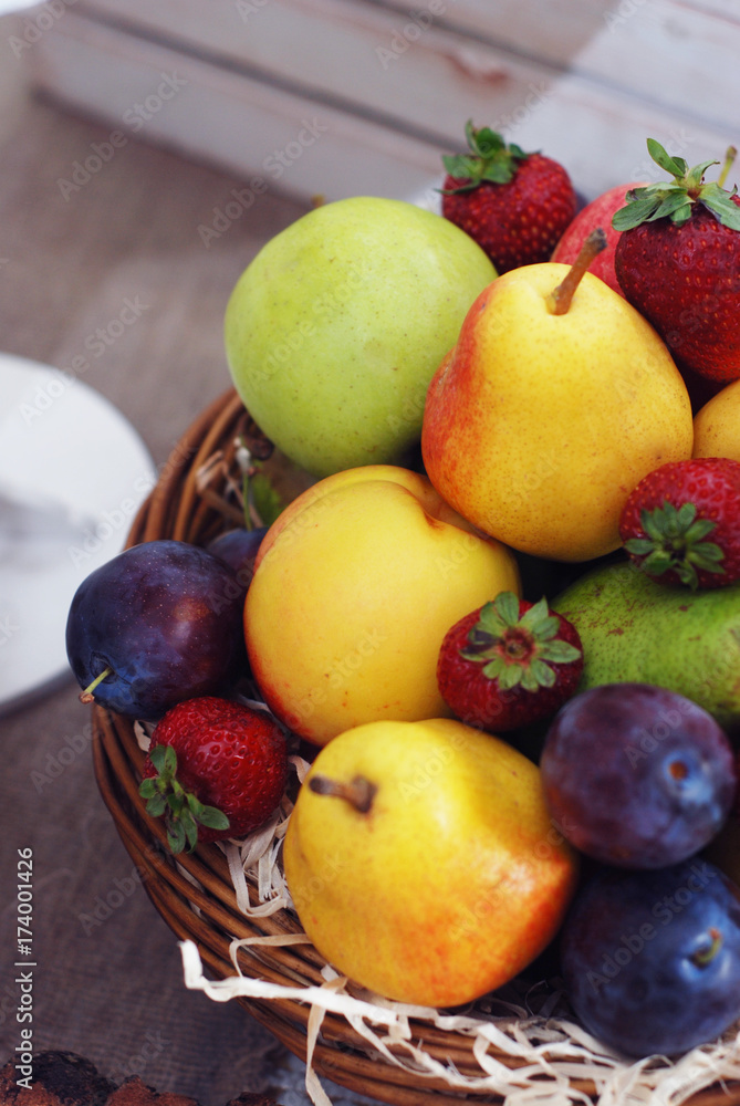Basket of fresh organic fruits. Apples, pears, plums, strawberry. Basket of fresh organic fruits. Apples, pears, plums, strawberry.