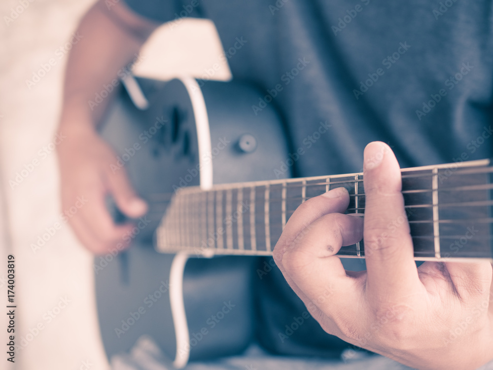 Fototapeta premium A man's hand plays guitar during festive times and parties.