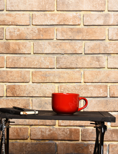 tea or coffee cup with copybook and pen