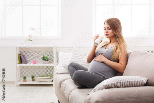 Pregnant woman drinking glass of milk