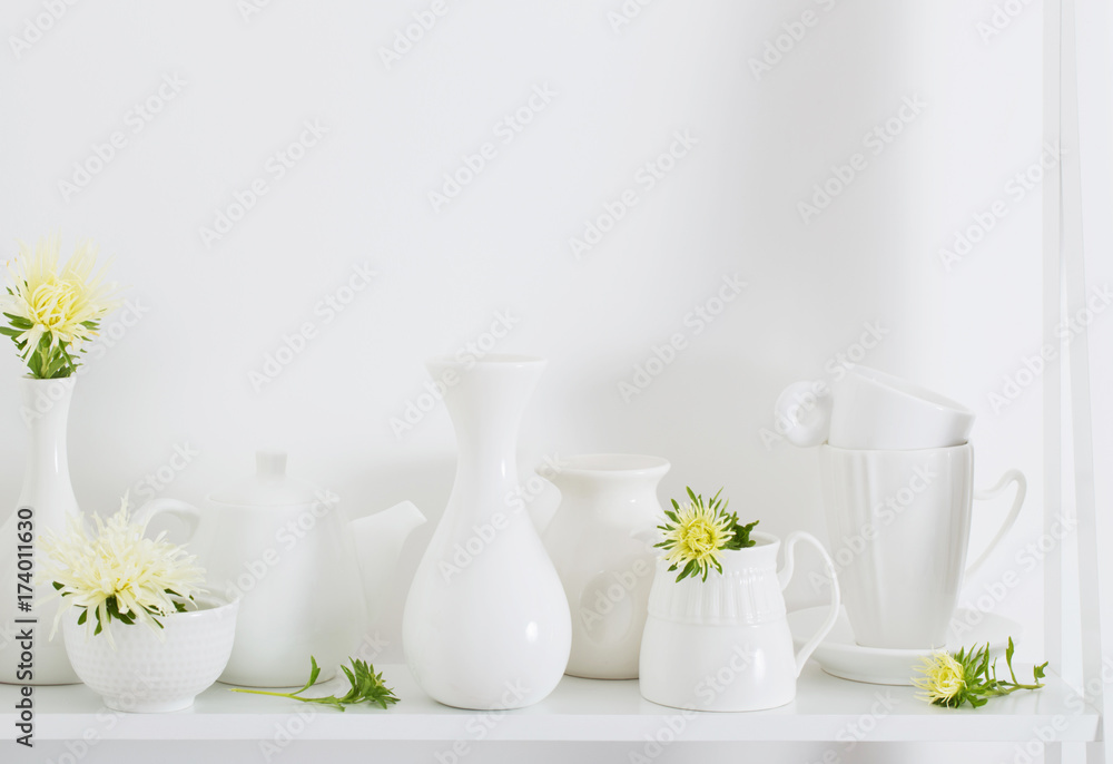 white dishware with flowers on wooden shelf white dishware with flowers on wooden shelf