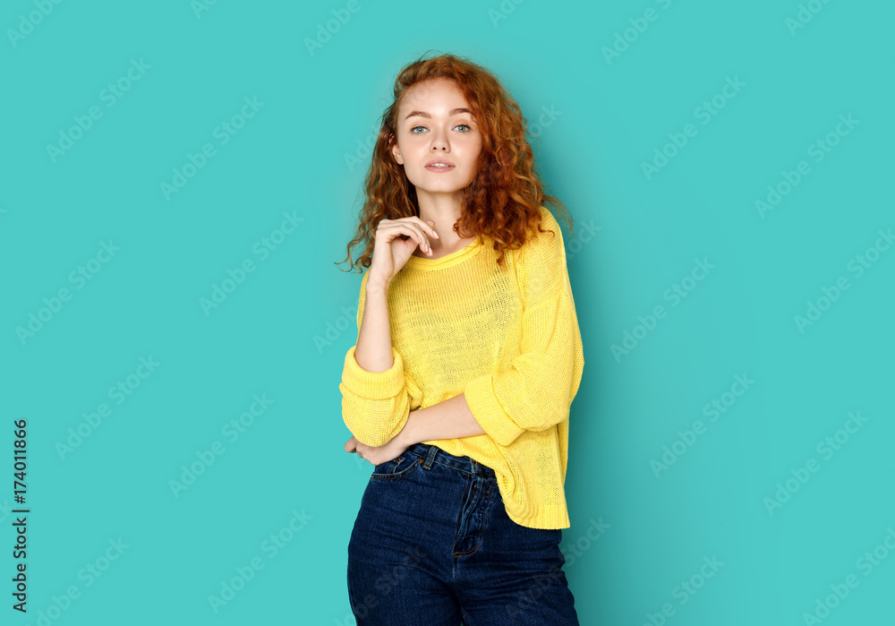 Cheerful girl in casual clothes posing at studio Cheerful girl in casual clothes posing at studio