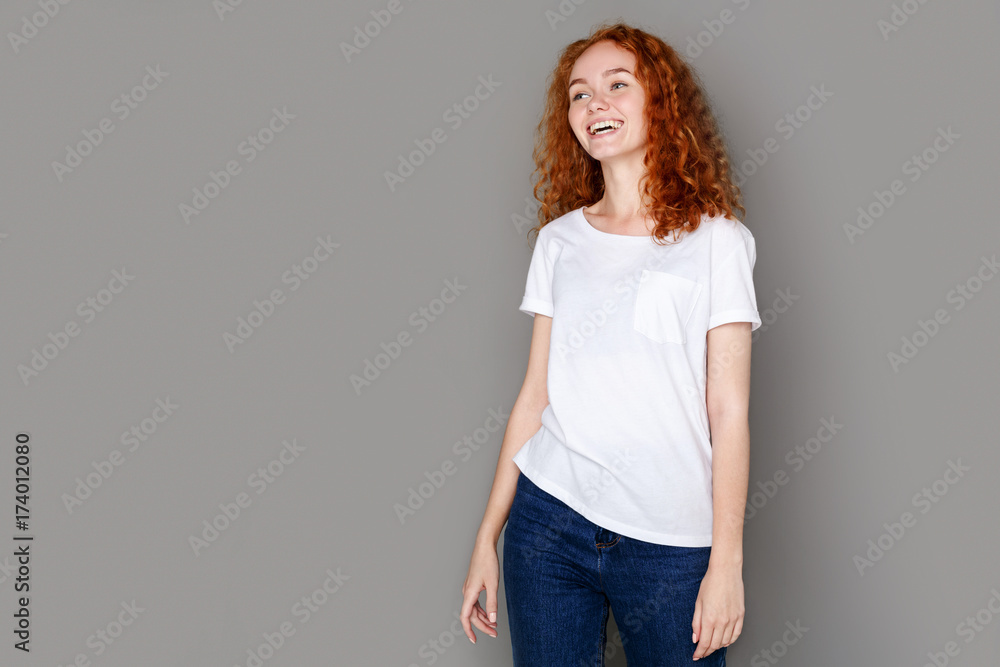 Laughing girl in casual clothes posing at studio Laughing girl in casual clothes posing at studio