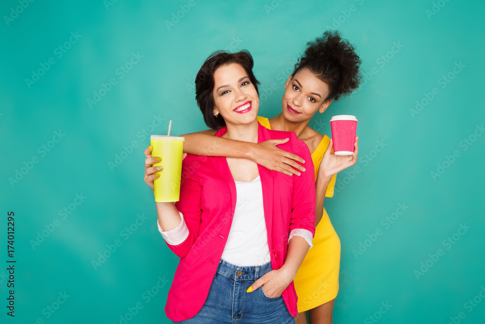 Two girlfriends having fun at azur studio background Two girlfriends having fun at azur studio background