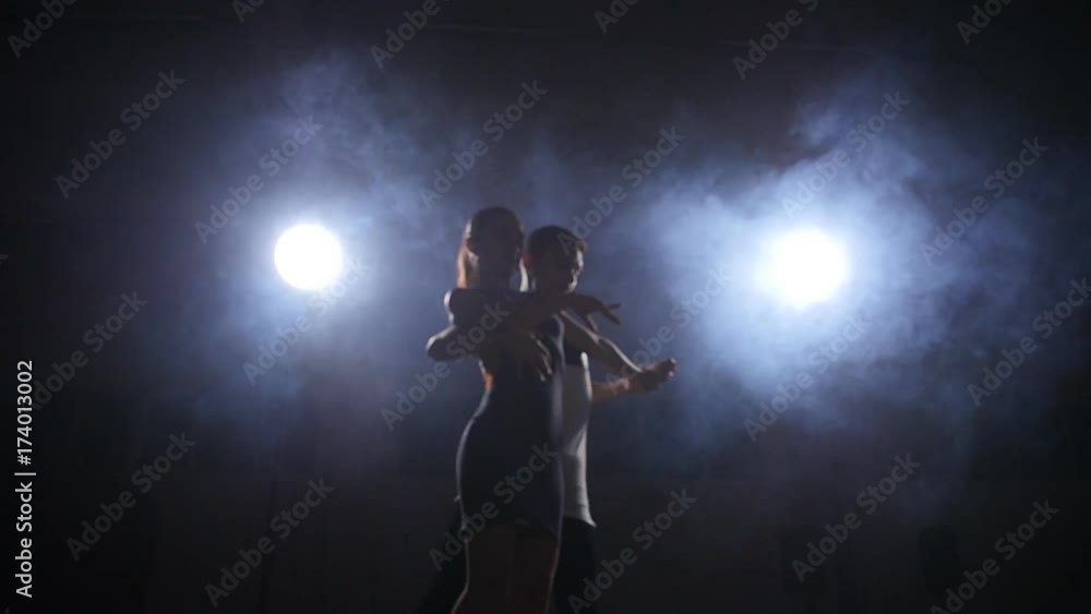 Beauty couple dancing bachata in dark room Beauty couple dancing bachata in dark room