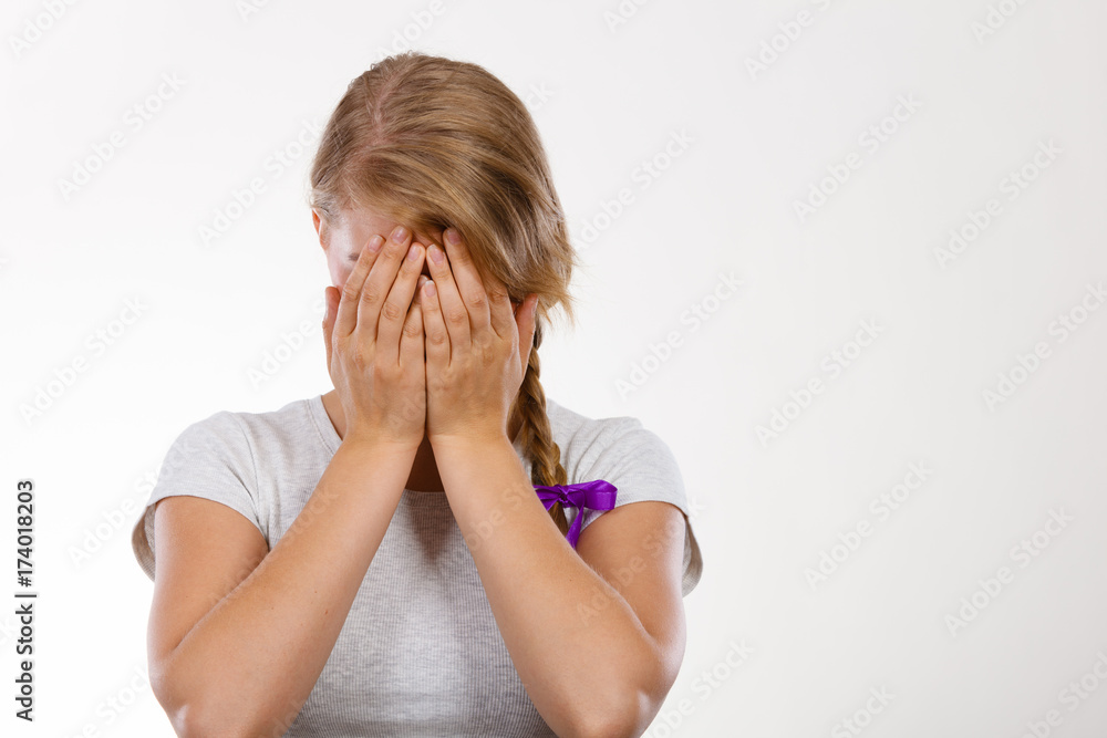 Shy teenage girl hiding face behind hand Shy teenage girl hiding face behind hand