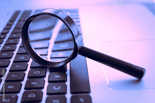 Magnifying glass on laptop