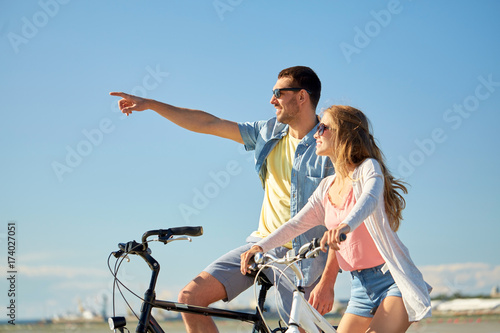 happy young couple riding bicycles at seaside © Syda Productions