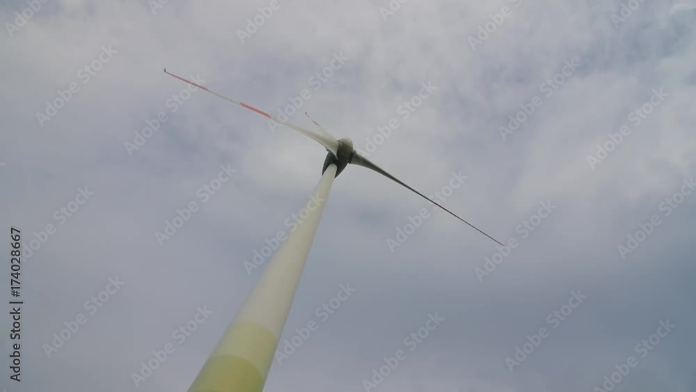 Wind turbine over stormy cloudy sky using renewable energy to generate electrical power. Renewable energy is most environmental way of power generation. Wind turbine over stormy cloudy sky using renewable energy to generate electrical power. Renewable energy is most environmental way of power generation.