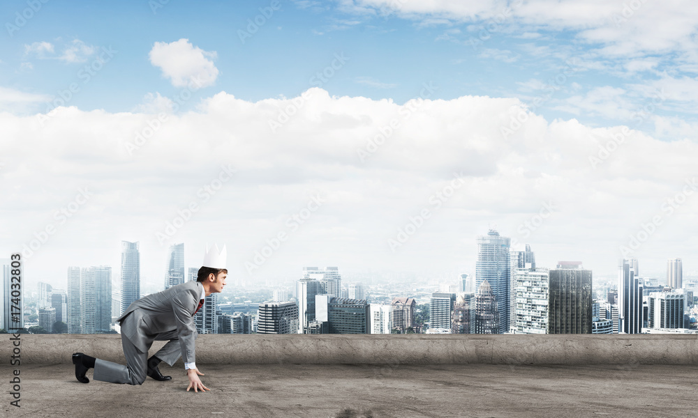 King businessman in elegant suit running on building roof and business center at background King businessman in elegant suit running on building roof and business center at background