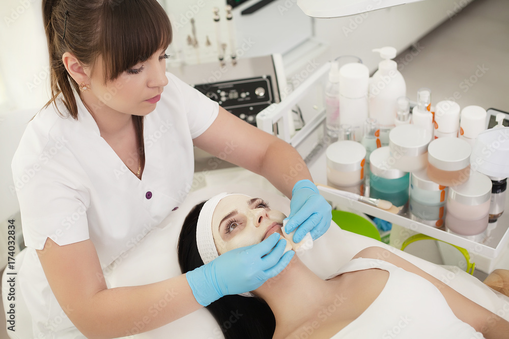 Girl At Spa Salon. Beautician Applying White Cosmetic Powder Girl At Spa Salon. Beautician Applying White Cosmetic Powder