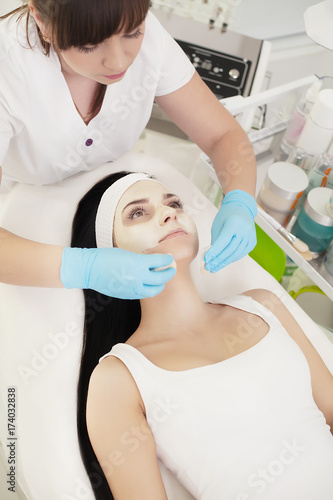 Girl At Spa Salon. Beautician Applying White Cosmetic Powder