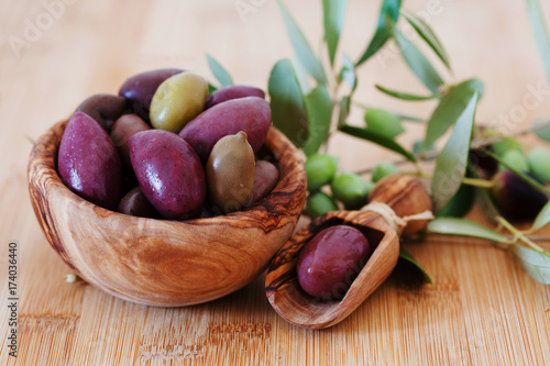 olives on wooden background, kalamata, kalamon, green olives photo