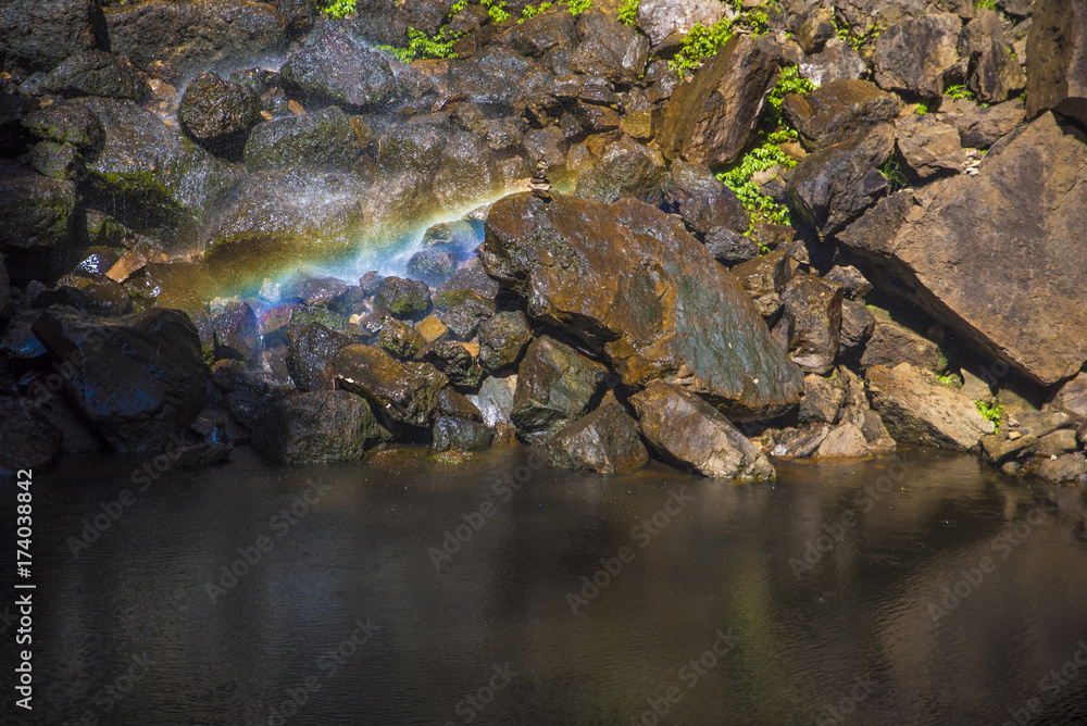 Magical Rainbow created by waterfall fallin on stone formation situated next to a water hole. Magical Rainbow created by waterfall fallin on stone formation situated next to a water hole.