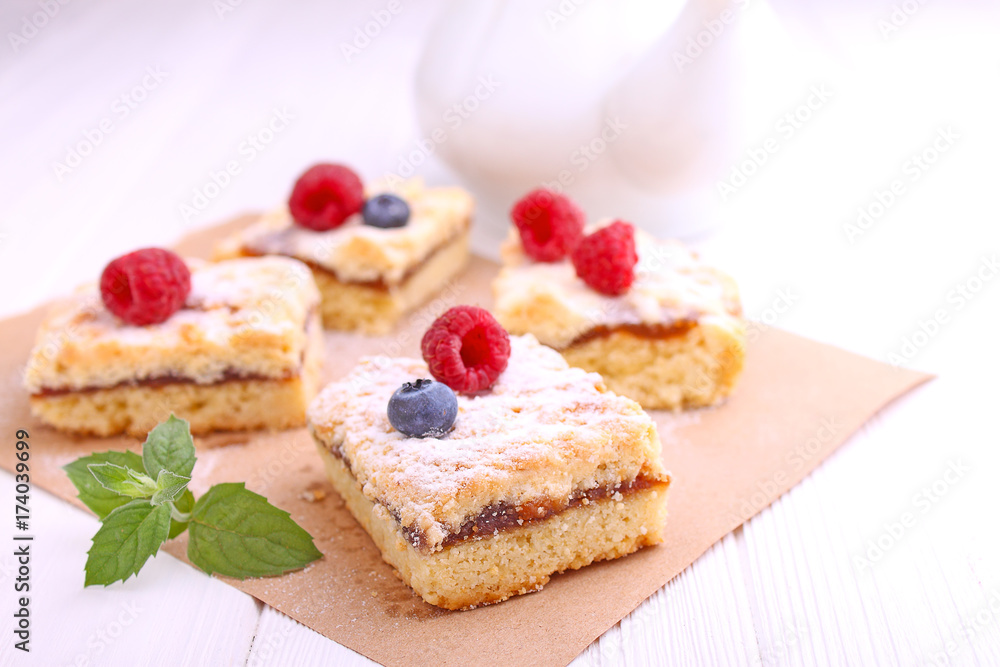 Homemade pie with berries cut into slices on a white background Homemade pie with berries cut into slices on a white background