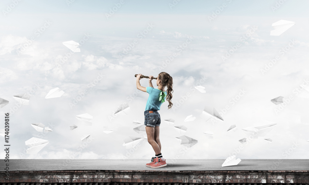 Concept of careless happy childhood with girl exploring this wor Concept of careless happy childhood with girl exploring this wor