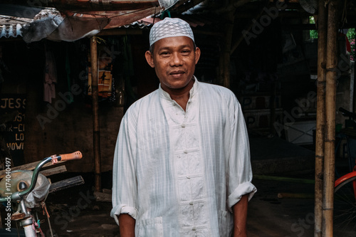 Indonesian Middleaged man runs a fish business on local market photo