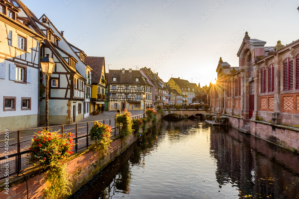 Beautiful view of the historic town of Colmar, also known as Little Venice, boat ride along traditional colorful houses on idyllic river Lauch in summer, Colmar, Alsace, France - obrazy, fototapety, plakaty 