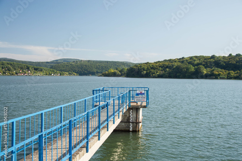 Fototapeta Naklejka Na Ścianę i Meble -  Lake with a pier and blue railing