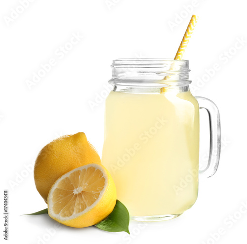 Mason jar with fresh lemon juice on white background