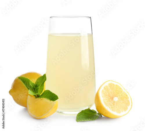 Glass of fresh lemon juice on white background