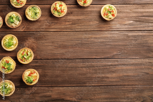 Broccoli quiche tartlets on wooden table