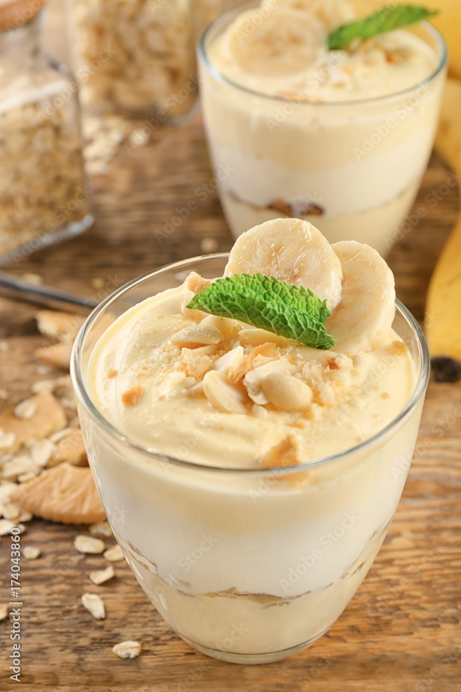 Glass with delicious banana pudding on table Glass with delicious banana pudding on table