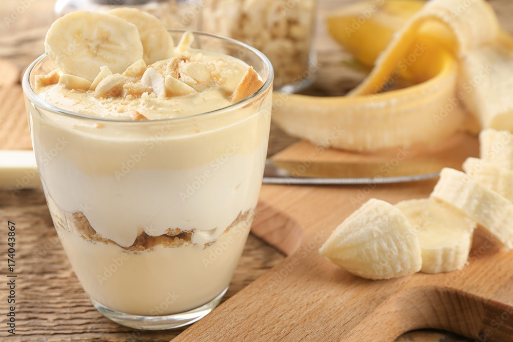 Glass with delicious banana pudding on table Glass with delicious banana pudding on table