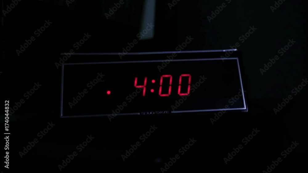 A man gropes for the alarm clock at 4:00 AM